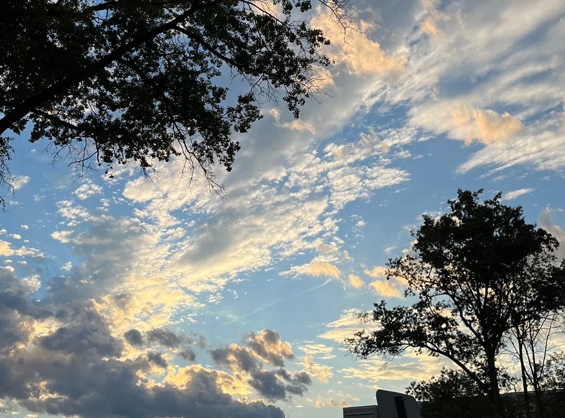 Beautiful blue sky and white clouds with trees in the background